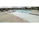 Community pool featuring a zero depth entry, multiple swim lanes, and surrounding deck with lounge chairs at 1211 Calder Dr, Indian Trail, NC 28079