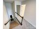 Carpeted staircase with wooden railing, leading to multiple rooms with open doorways at 1211 Calder Dr, Indian Trail, NC 28079