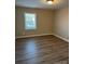 Cozy bedroom with window, neutral walls, and modern flooring at 1228 Archdale Dr # G, Charlotte, NC 28217