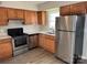 Well-lit kitchen features stainless steel appliances, light countertops, and wood cabinets at 1228 Archdale Dr # G, Charlotte, NC 28217