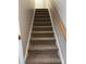 Carpeted staircase with handrail leading to the upper level of the home at 1228 Archdale Dr # G, Charlotte, NC 28217