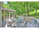 Enjoy outdoor dining on this home's spacious back deck overlooking the lush, wooded yard at 14203 Queens Carriage Pl, Charlotte, NC 28278