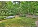 Private backyard featuring a boat and a lush lawn near a lush, wooded area and patio at 14203 Queens Carriage Pl, Charlotte, NC 28278