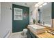 Stylish bathroom with dark teal shiplap, vessel sink, and modern fixtures, offering a unique, nautical design at 14203 Queens Carriage Pl, Charlotte, NC 28278