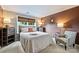 Cozy bedroom with accent wallpaper, neutral tones and comfortable decor that offers a serene atmosphere at 14203 Queens Carriage Pl, Charlotte, NC 28278