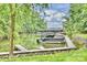 Beautiful view of the boat dock with covered boat slips and boats on a serene lake at 14203 Queens Carriage Pl, Charlotte, NC 28278