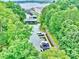 Aerial view of boat slips on a lake with lush green trees surrounding the water at 14203 Queens Carriage Pl, Charlotte, NC 28278