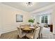 Tasteful dining room with ample seating, stylish decor, and open view to the living area at 14203 Queens Carriage Pl, Charlotte, NC 28278