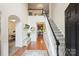 Grand foyer with hardwood floors, staircase, wainscoting, and a view to the dining room and hallway at 14203 Queens Carriage Pl, Charlotte, NC 28278