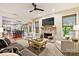 Open-concept living room and kitchen area with brick fireplace, ceiling fan, and comfortable seating arrangement at 14203 Queens Carriage Pl, Charlotte, NC 28278