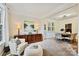 Comfortable living room featuring a large window, a stylish cabinet, and dining room view at 14203 Queens Carriage Pl, Charlotte, NC 28278