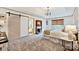 A spacious main bedroom featuring a tray ceiling, fireplace, and sliding barn door to the bathroom at 14203 Queens Carriage Pl, Charlotte, NC 28278