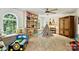 Spacious playroom featuring a built-in bookshelf and large window bench, perfect for activities at 14203 Queens Carriage Pl, Charlotte, NC 28278