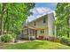 Beautiful home featuring an expansive yard, back deck, screened porch and a lush tree line at 14203 Queens Carriage Pl, Charlotte, NC 28278