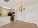 Kitchen with wooden cabinets, appliances, and hardwood floors adjacent to the dining area at 14347 San Paolo Ln, Charlotte, NC 28277