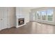 Living room with fireplace, lots of natural light from many windows, and access to the patio at 14347 San Paolo Ln, Charlotte, NC 28277