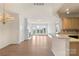 Bright living room featuring hardwood floors, a cozy fireplace, and large windows with outdoor views at 14347 San Paolo Ln, Charlotte, NC 28277