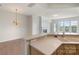 Well-lit living room with hardwood floors, fireplace, and kitchen view, creating an inviting atmosphere at 14347 San Paolo Ln, Charlotte, NC 28277