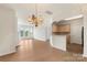 Open-concept living room and kitchen area with hardwood floors and abundant natural light at 14347 San Paolo Ln, Charlotte, NC 28277