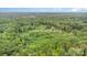 Expansive forest with estate that includes gray octagon house, lawn, RV with shed, and long driveway at 147 Buck And Doe Ln, Statesville, NC 28625
