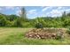 Landscaping feature with rocks, a small retaining wall, and greenery along the yard at 147 Buck And Doe Ln, Statesville, NC 28625