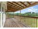 Spacious porch with wooden flooring and railings overlooking a lush green landscape and views of the surrounding trees at 147 Buck And Doe Ln, Statesville, NC 28625