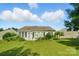 Backyard featuring a well-maintained lawn, mature landscaping, and a charming single-story home at 15116 Legend Oaks Ct, Fort Mill, SC 29707