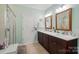 Modern bathroom featuring double vanity, framed mirrors, and walk-in shower at 15116 Legend Oaks Ct, Fort Mill, SC 29707