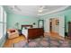 Inviting bedroom with tray ceiling, hardwood floors, light walls and door leading to other rooms at 15116 Legend Oaks Ct, Fort Mill, SC 29707