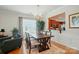 Inviting dining room featuring hardwood floors, a stylish chandelier, and ample natural light at 15116 Legend Oaks Ct, Fort Mill, SC 29707