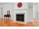 Close up of an elegant fireplace and mantle in a living room with hardwood floors at 15116 Legend Oaks Ct, Fort Mill, SC 29707