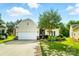 Charming home featuring a two-car garage, manicured lawn, and beautiful landscaping with a stone-accented facade at 15116 Legend Oaks Ct, Fort Mill, SC 29707