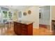 Stylish kitchen island with granite countertops, custom cabinetry, and an adjacent breakfast area at 15116 Legend Oaks Ct, Fort Mill, SC 29707