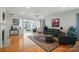 Bright living room with hardwood floors, fireplace, and elegant furnishings, flowing into an adjoining sitting room at 15116 Legend Oaks Ct, Fort Mill, SC 29707