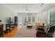 Bright sunroom featuring ample natural light, neutral furniture and a ceiling fan at 15116 Legend Oaks Ct, Fort Mill, SC 29707