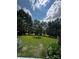 View of expansive backyard area with large trees at 15116 Legend Oaks Ct, Fort Mill, SC 29707