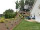 A backyard area featuring a patio with fire pit, blue adirondack chairs, and stairs to a backyard view at 15250 Windward Ln, Lancaster, SC 29720