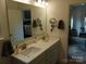 Stylish bathroom showcasing a double vanity with quartz countertops, a wide mirror, and access to the bedroom at 15250 Windward Ln, Lancaster, SC 29720