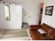 This bedroom features a large closet with drawers, a leather sofa, and a decorative rug at 15250 Windward Ln, Lancaster, SC 29720