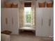 The bedroom features built in closets, a window with bench seating, and natural light at 15250 Windward Ln, Lancaster, SC 29720