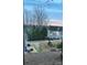 Scenic exterior view featuring a lake, trees, and a patio with chairs in the distance at 15250 Windward Ln, Lancaster, SC 29720