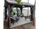 Cozy gazebo features comfortable seating, a fire pit, and outdoor lighting, perfect for entertaining at 15250 Windward Ln, Lancaster, SC 29720