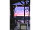 Scenic gazebo with comfortable seating and ambient string lights overlooking a colorful sunset at 15250 Windward Ln, Lancaster, SC 29720