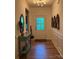 Inviting hallway with hardwood floors, decorative wall panels, and stylish console table at 15250 Windward Ln, Lancaster, SC 29720