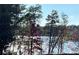 A scenic view from the property overlooking a shimmering lake with lush trees at 15250 Windward Ln, Lancaster, SC 29720