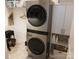The modern laundry area features a stackable washer and dryer, and handy shelving with storage at 15250 Windward Ln, Lancaster, SC 29720