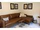 Inviting living room featuring a brown leather sofa, a striped rug, and framed art on the walls at 15250 Windward Ln, Lancaster, SC 29720