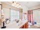 Well-lit bathroom featuring a vanity with modern fixtures, a large mirror, and a shower-tub combination at 1575 Williamsburg Dr, Rock Hill, SC 29732
