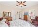 Bedroom featuring a ceiling fan, closet and doorway to the bathroom. Neutral paint and carpet flooring at 1575 Williamsburg Dr, Rock Hill, SC 29732