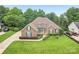 Beautiful aerial view of brick home with manicured lawn and mature trees. Offers great curb appeal at 1575 Williamsburg Dr, Rock Hill, SC 29732